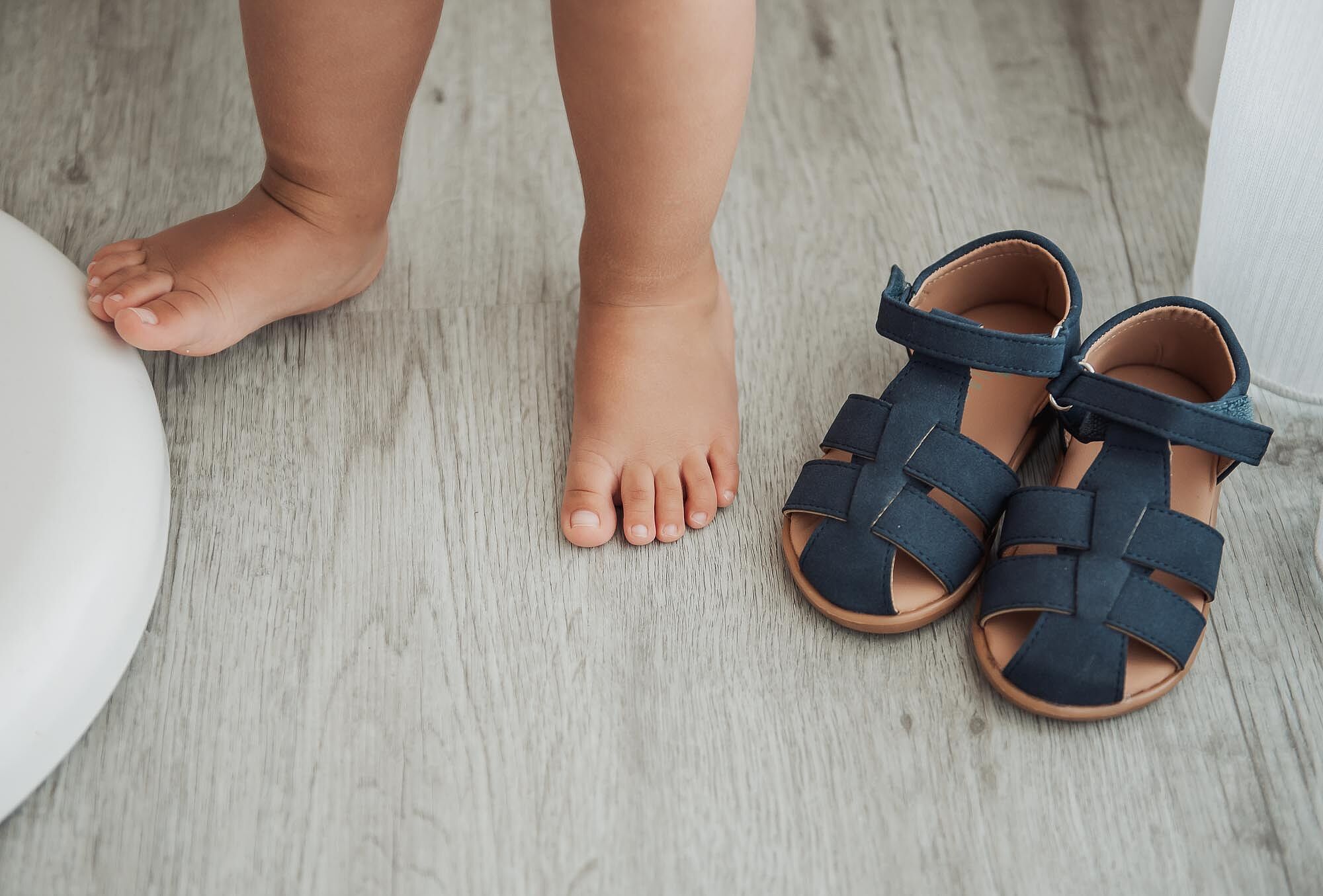 pes de bebe ao lado dos sapatinhos
