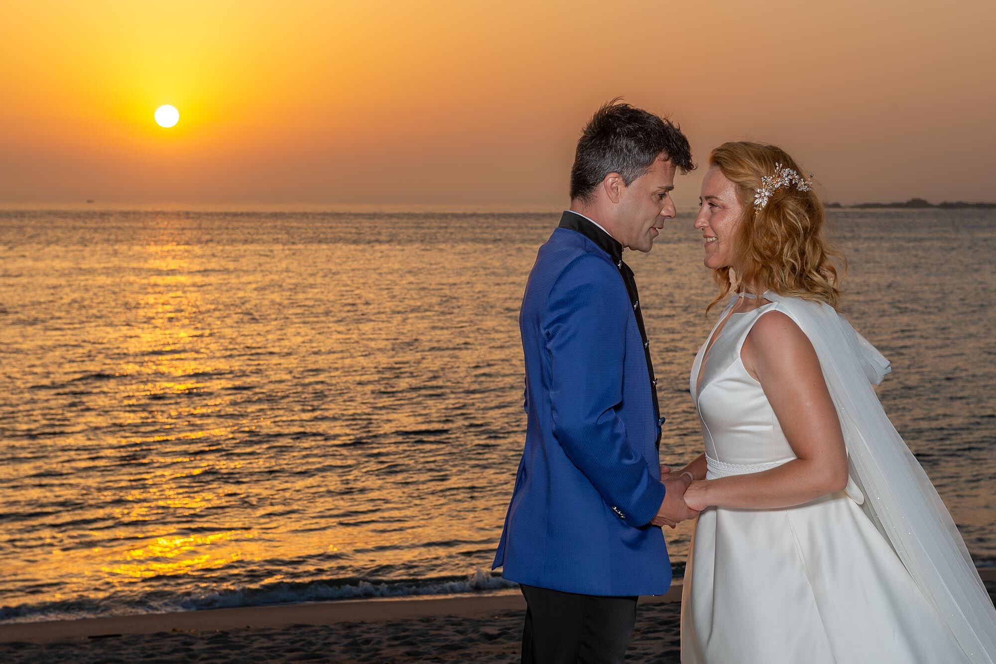 Casal na praia a olhar um par ao outro apaixonadamente