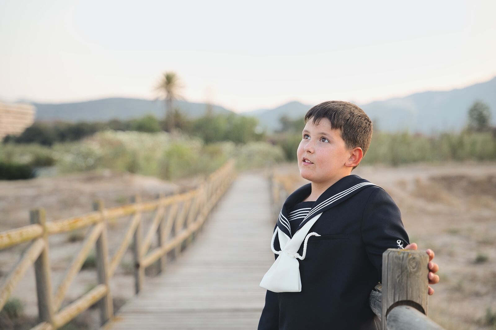 Niño caminando por un camino rural con paisajes al fondo en la playa de Gandía
